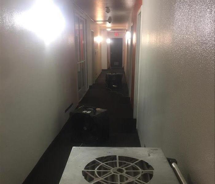 SERVPRO technicians use water dehydration extraction fans to quickly dry water damage in flooring and carpet of Santee motel