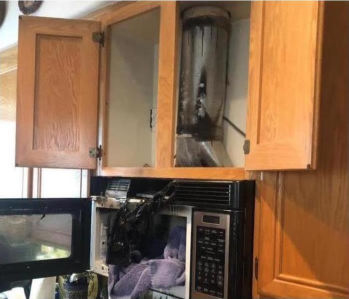 Fire damage in San Diego kitchen above the microwave and stove