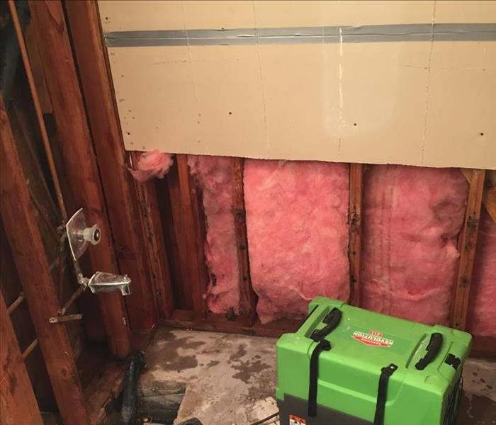 SERVPRO dehydration machines drying out bathroom flooring where leaky pipes caused water damage.