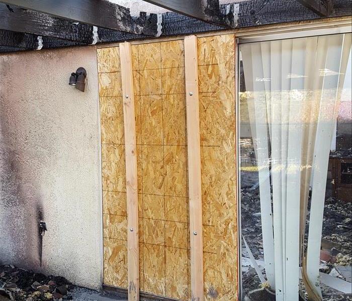 SERVPRO of Santee/Lakeside technicians board up the sliding glass door to keep animals and other damage out