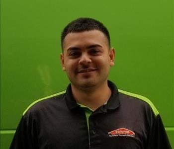 Male SERVPRO technician Ruben in front of green background