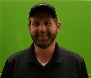 Zach Miller male SERVPRO Operations Manager in front of green background
