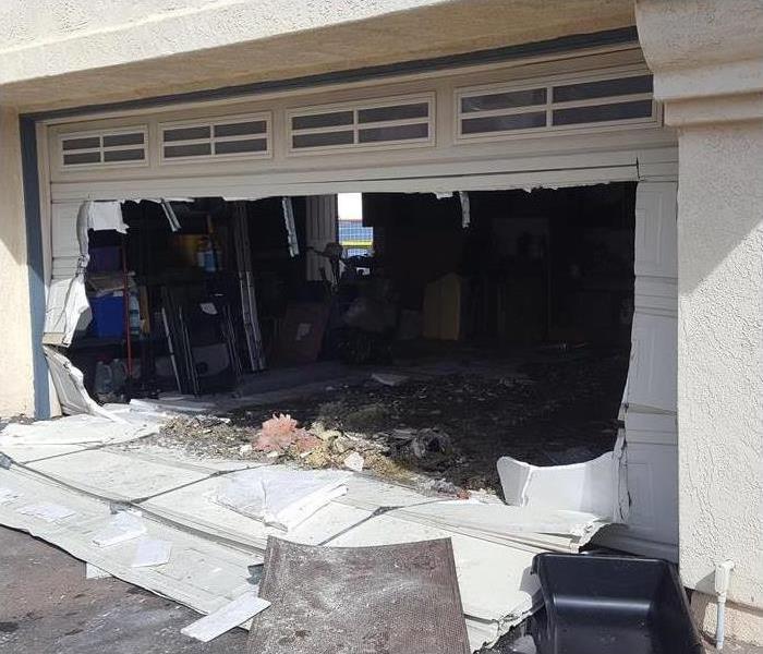 San Diego home's garage door destroyed by residential fire and smoke damage